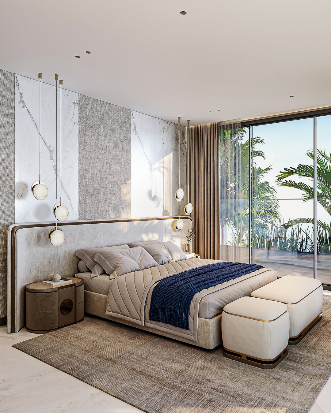 Primary bedroom with pale stone, soft upholstery, hanging lights and a blue bed throw.